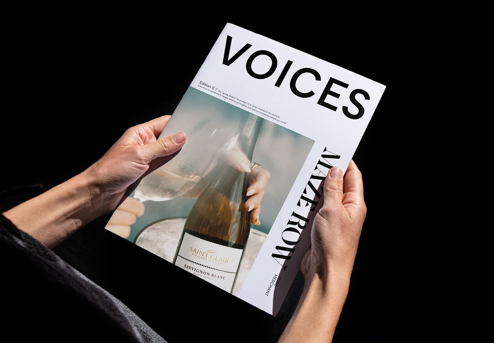 Person holding a copying of Fall 2024 Voices magazine.